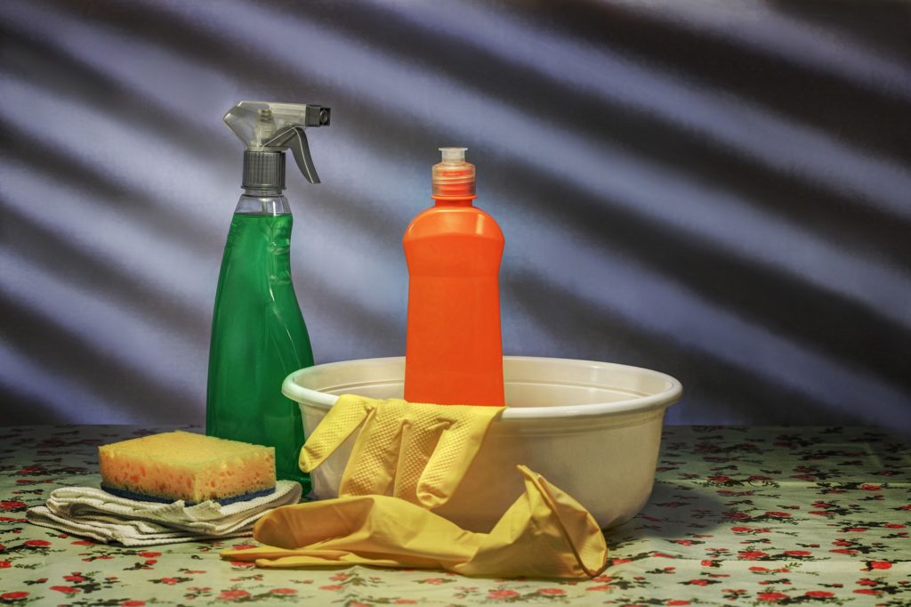 Dish soap, rubber gloves, sponge and spray bottle. Everything you need to clean a microwave with dish soap.