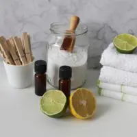 Key components to removing smell from a microwave. Here are lemons, essential oils, baking soda and cleaning clothes.