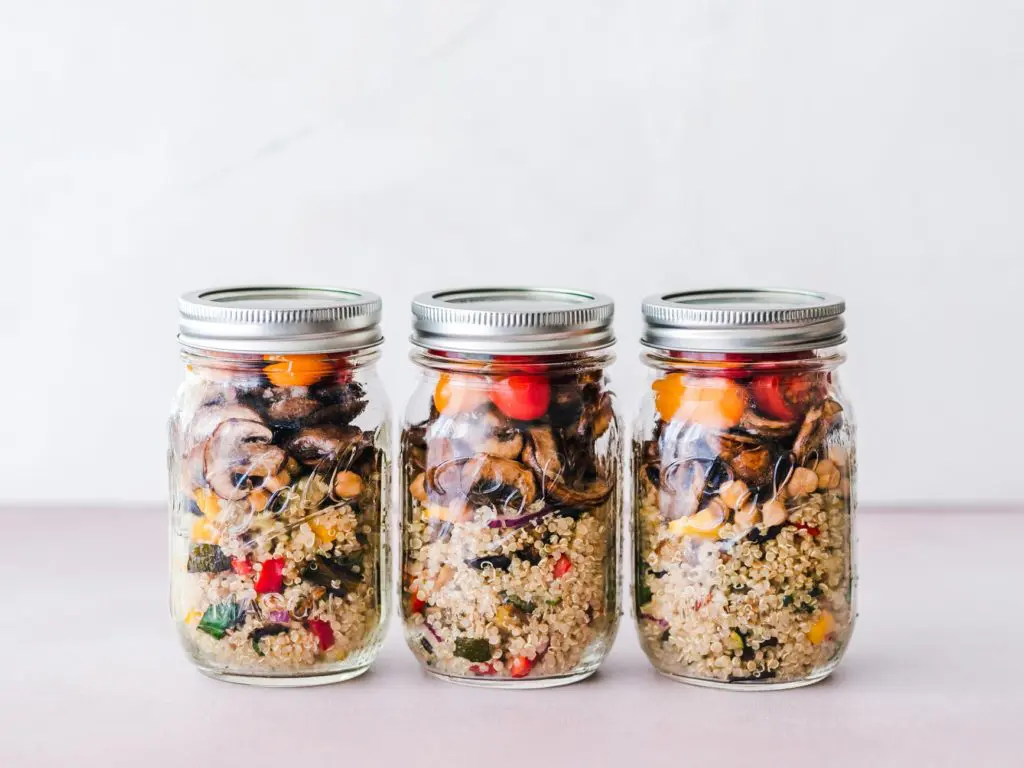three mason jars filled with a simple meal prep three mason jars filled with a simple meal prep of quinoa and assorted roasted vegetables